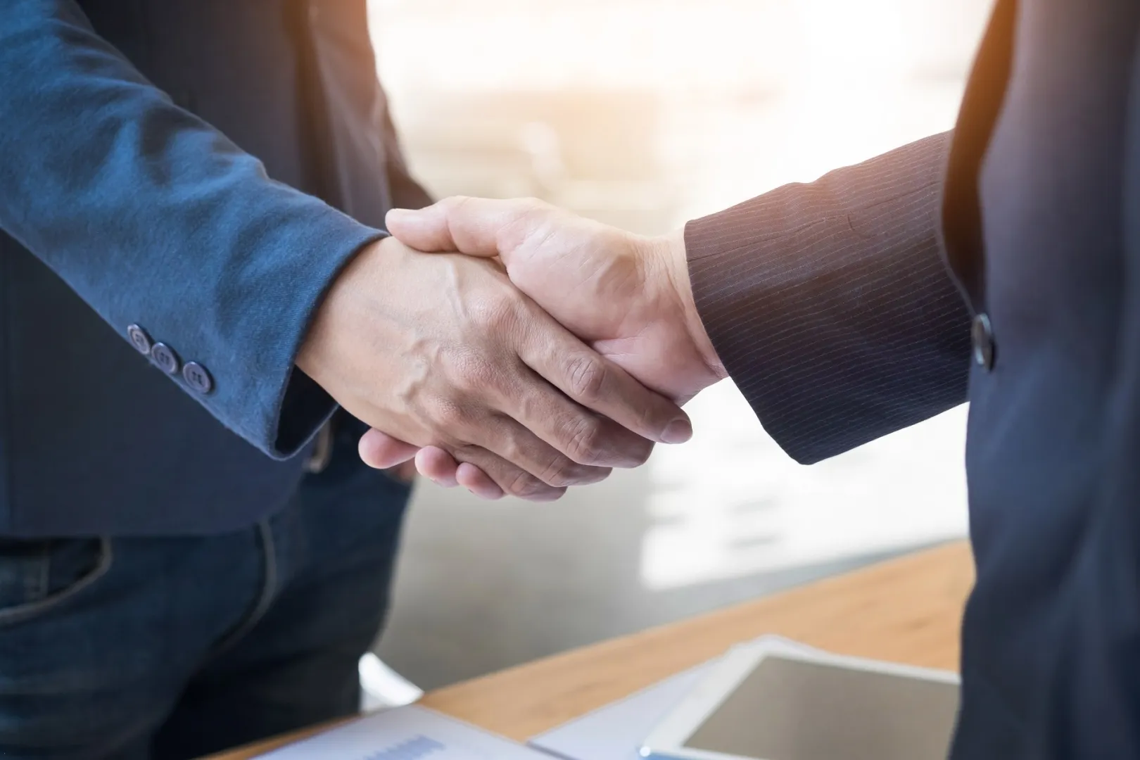 men shaking their hands as a sign of collaboration